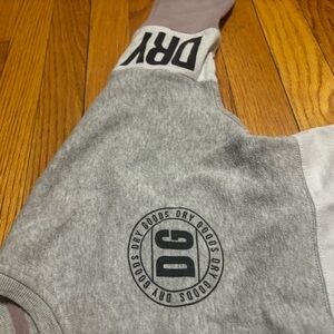 Dry goods is the brand. Size Large. Crew Neck. Light Grey. Purple.